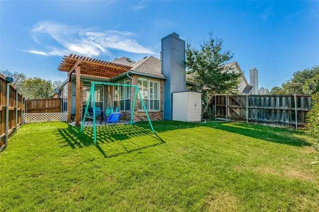 a view of a house with a big yard and potted plants
