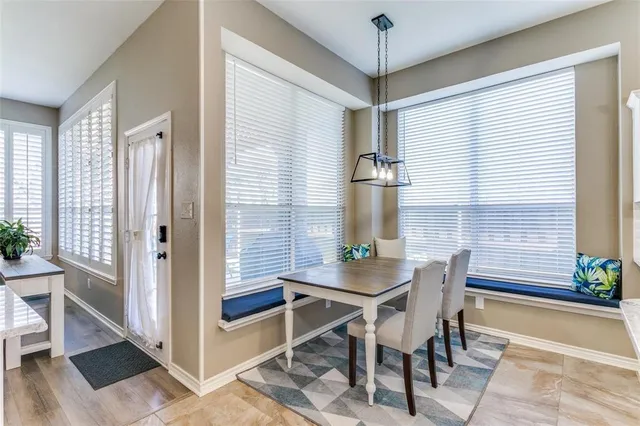 a view of a dining room with furniture and window