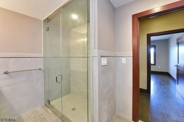a bathroom with a glass shower door and a window