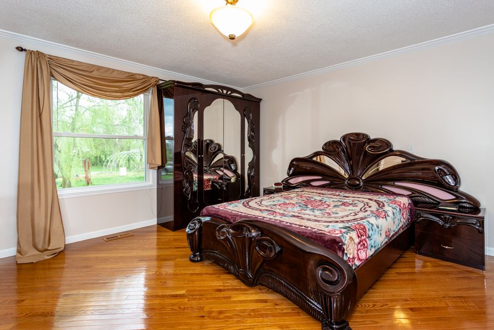 152 Millers Road Bridgewater, VA 22812 - Photo 12 of 50 a bedroom with a bed next to a window