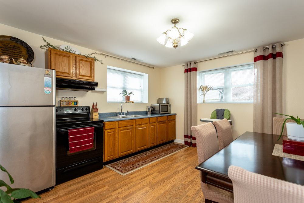 152 Millers Road Bridgewater, VA 22812 - Photo 26 of 50 a kitchen with stainless steel appliances granite countertop a refrigerator a sink dishwasher a stove and white countertops with wooden floor