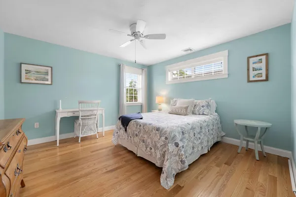 a bedroom with a bed and a table chair