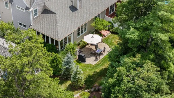 a backyard of a house with a yard and outdoor seating