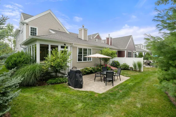 a view of a house with a backyard and a patio