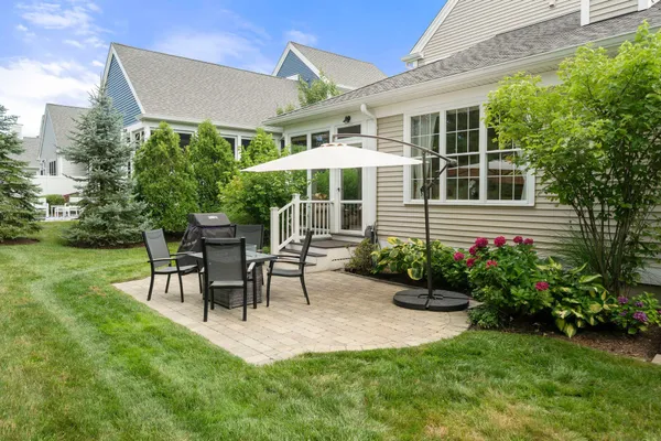 a view of a house with backyard sitting area and garden