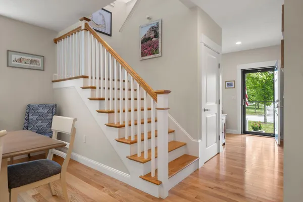 a view of entryway and hall with wooden floor