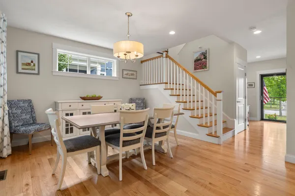 a view of a dining room with furniture wooden floor and chandelier