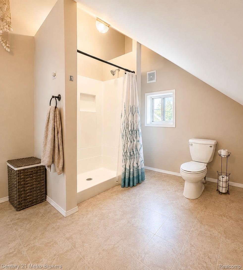 301 Field Road Clio, MI 48420 - Photo 14 of 32 Shower with a built-in niche and a single showerhead, set against a tiled floor
