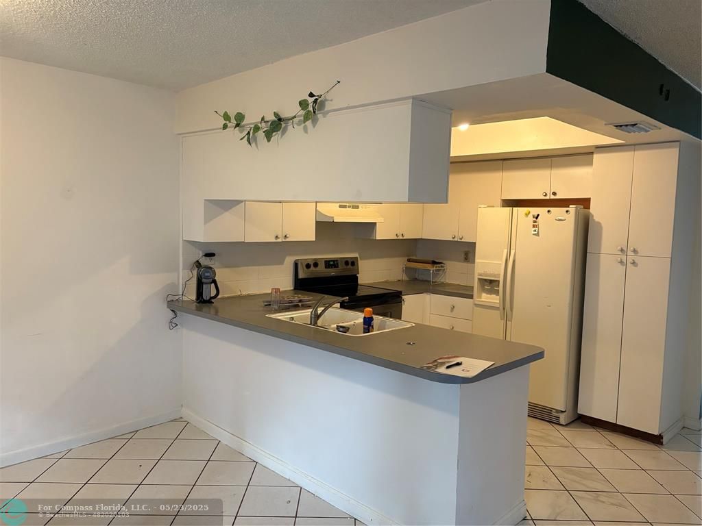 7659 Northwest 74th Avenue Tamarac, FL 33321 - Photo 3 of 11 a workspace with a sink