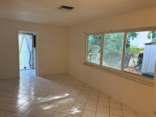 a view of an empty room and staircase
