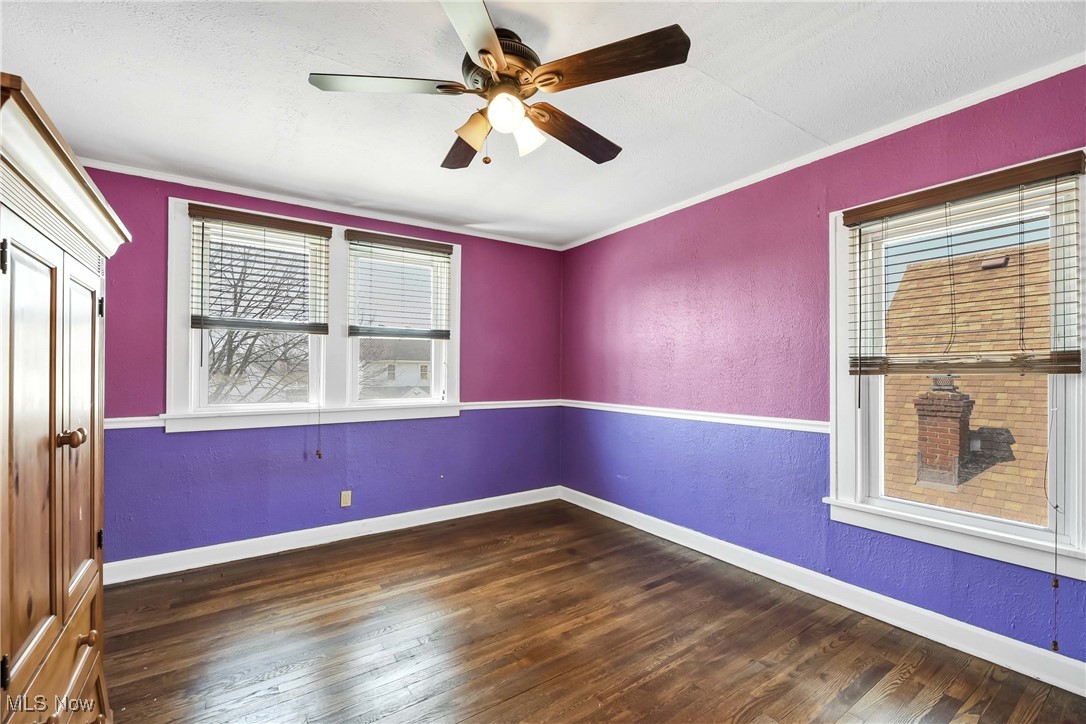 7700 Spring Garden Road Cleveland, OH 44129 - Photo 34 of 50 Spare room featuring wood finished floors, ceiling fan, baseboards, ornamental molding, and a textured wall