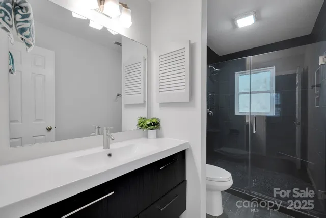 a bathroom with a toilet and a shower