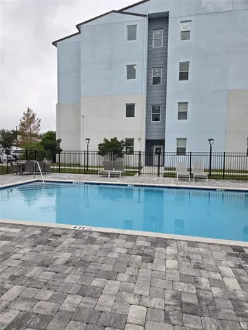 a view of swimming pool with outdoor seating