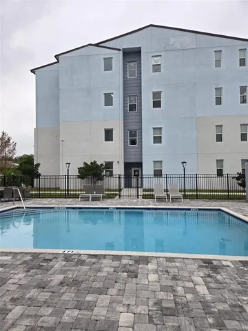 a view of a swimming pool with outdoor seating