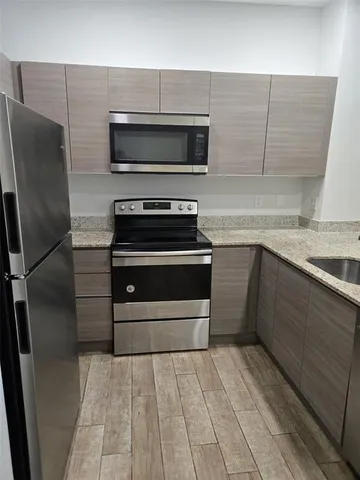 a kitchen with appliances and cabinets