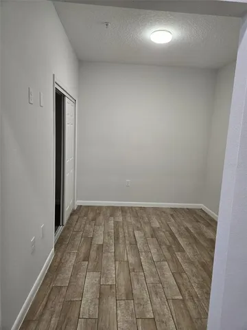 a view of an empty room and wooden floor