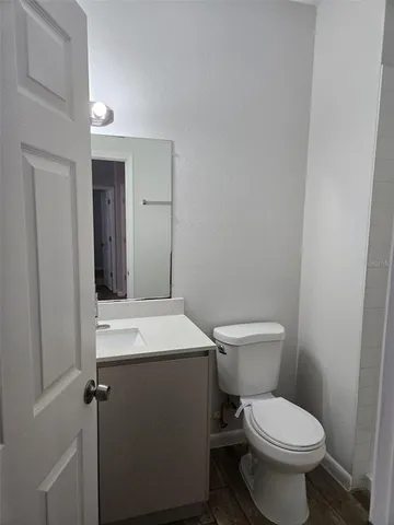 a white toilet sitting next to a bathroom sink