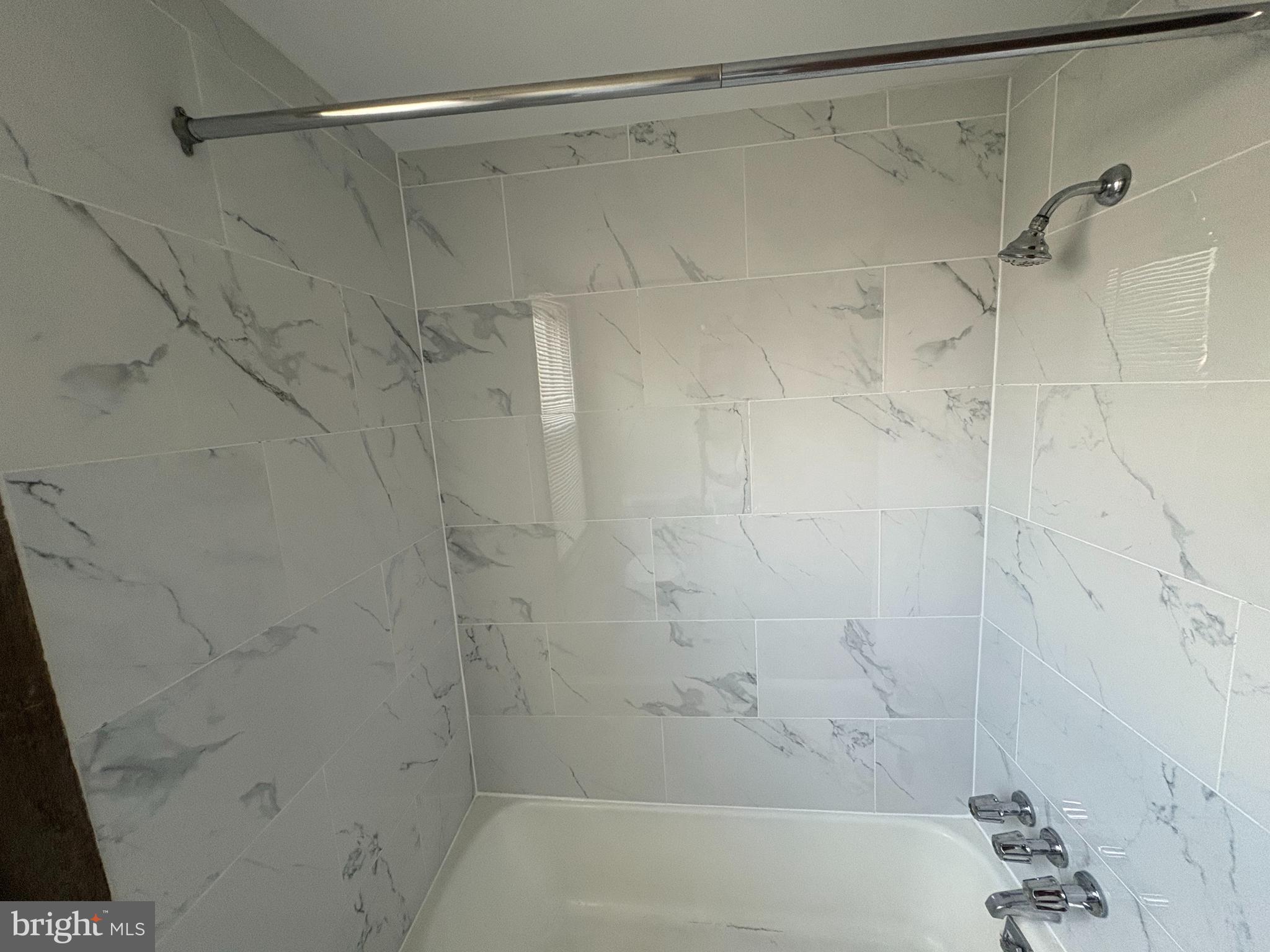 1405 Pennington Road, Unit 2A Ewing, NJ 08618 - Photo 2 of 12 a bathroom with a shower and a shower