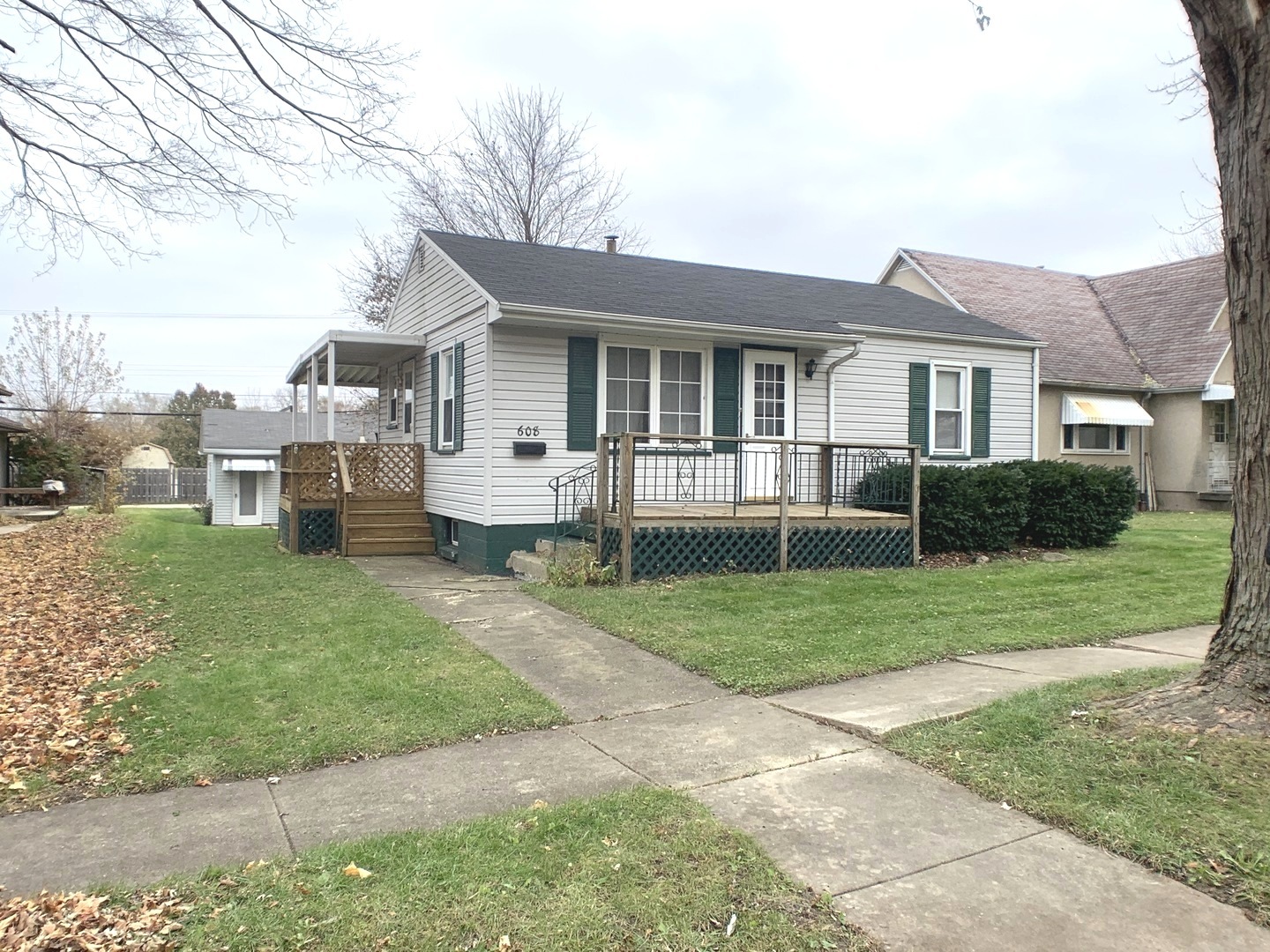 a front view of a house with a garden and yard