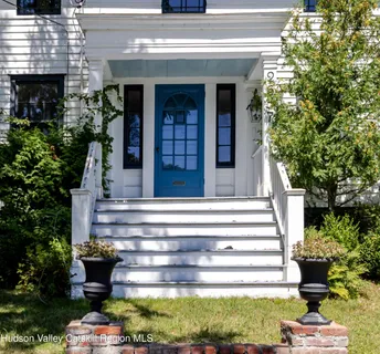 a view of an entryway with wooden floor and windows