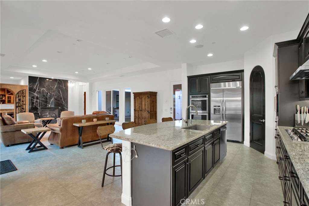 6 Cassis Circle Rancho Mirage, CA 92270 - Photo 31 of 74 a kitchen with stainless steel appliances granite countertop a stove and a refrigerator