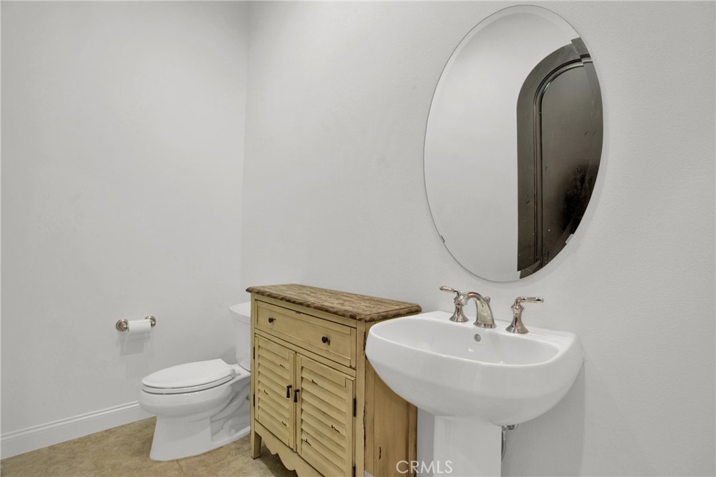 6 Cassis Circle Rancho Mirage, CA 92270 - Photo 37 of 74 a bathroom with a sink a toilet and a mirror