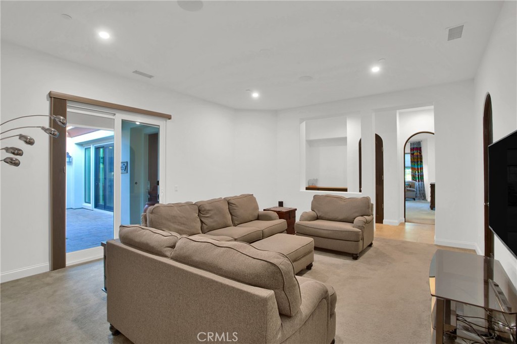6 Cassis Circle Rancho Mirage, CA 92270 - Photo 41 of 74 a living room with furniture and a potted plant