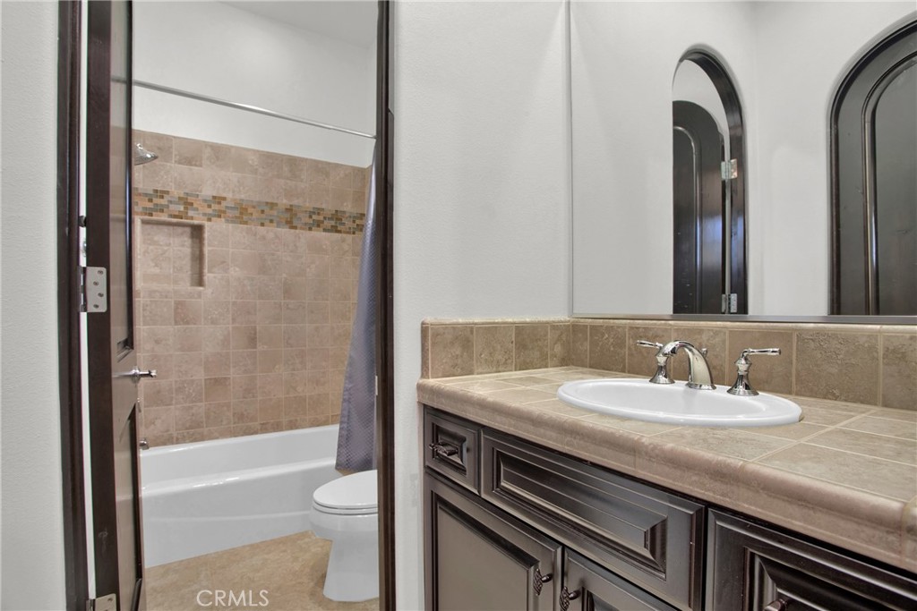 6 Cassis Circle Rancho Mirage, CA 92270 - Photo 42 of 74 a bathroom with a granite countertop sink toilet and shower