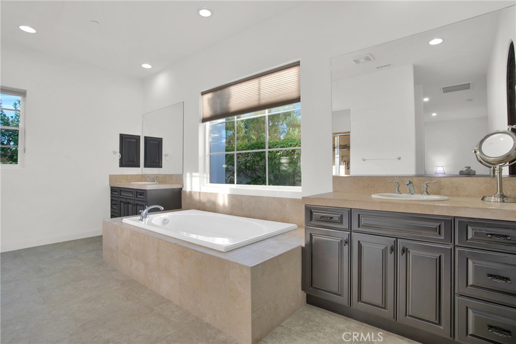 6 Cassis Circle Rancho Mirage, CA 92270 - Photo 52 of 74 a spacious bathroom with a sink a large mirror and a window