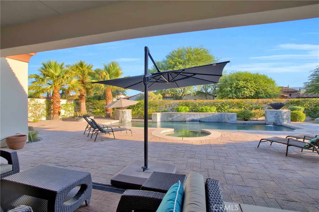 6 Cassis Circle Rancho Mirage, CA 92270 - Photo 59 of 74 a view of a swimming pool with a lounge chairs