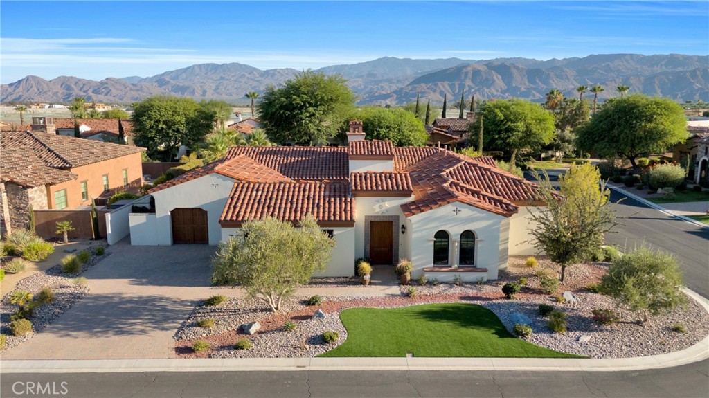 6 Cassis Circle Rancho Mirage, CA 92270 - Photo 6 of 74 a front view of a house with a garden and mountain view