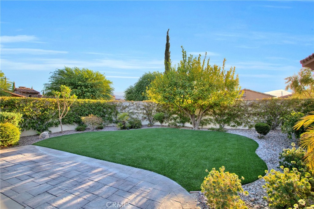 6 Cassis Circle Rancho Mirage, CA 92270 - Photo 66 of 74 a view of a garden with a building in the background