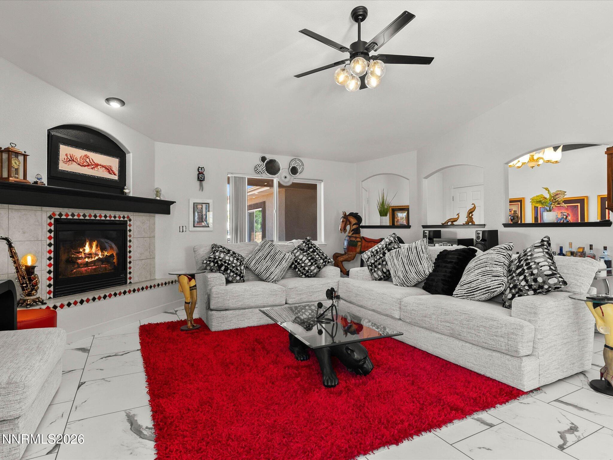 1080 Red Rock Road Fernley, NV 89408 - Photo 9 of 45 a living room with furniture a flat screen tv and a fireplace