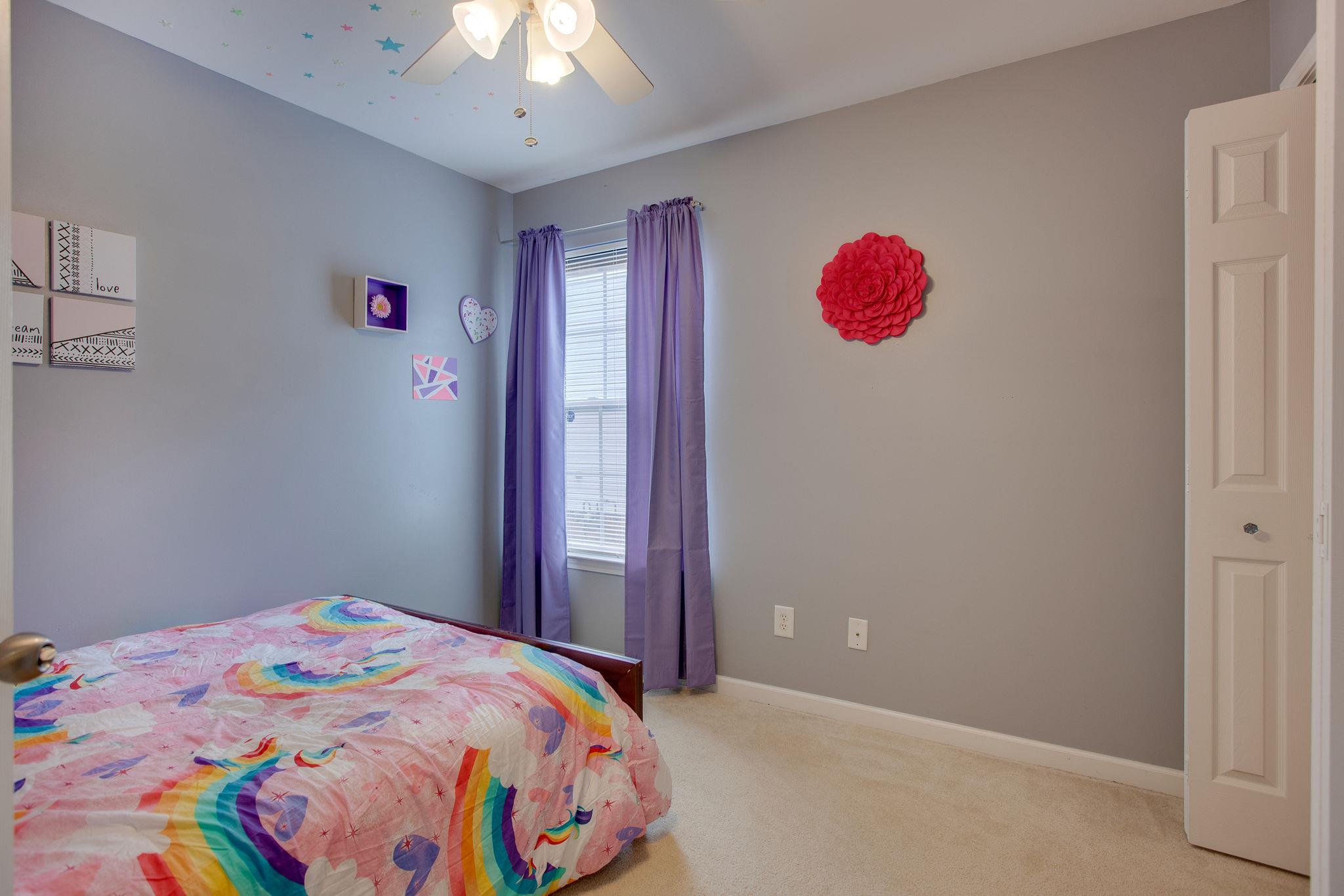 1046 Golf View Way Spring Hill, TN 37174 - Photo 14 of 22 a bedroom with a bed and a chandelier