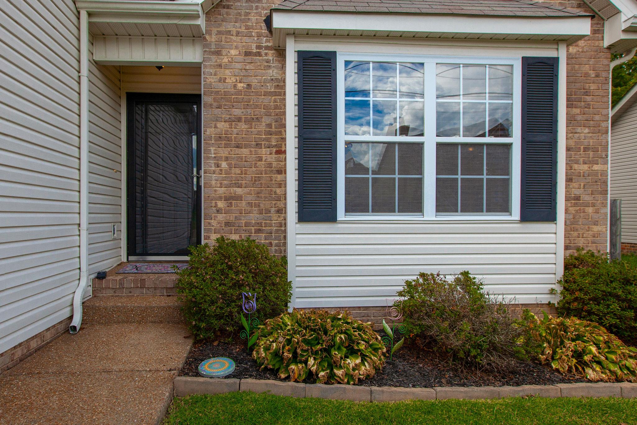 1046 Golf View Way Spring Hill, TN 37174 - Photo 3 of 22 a view of a house with potted plants and a yard