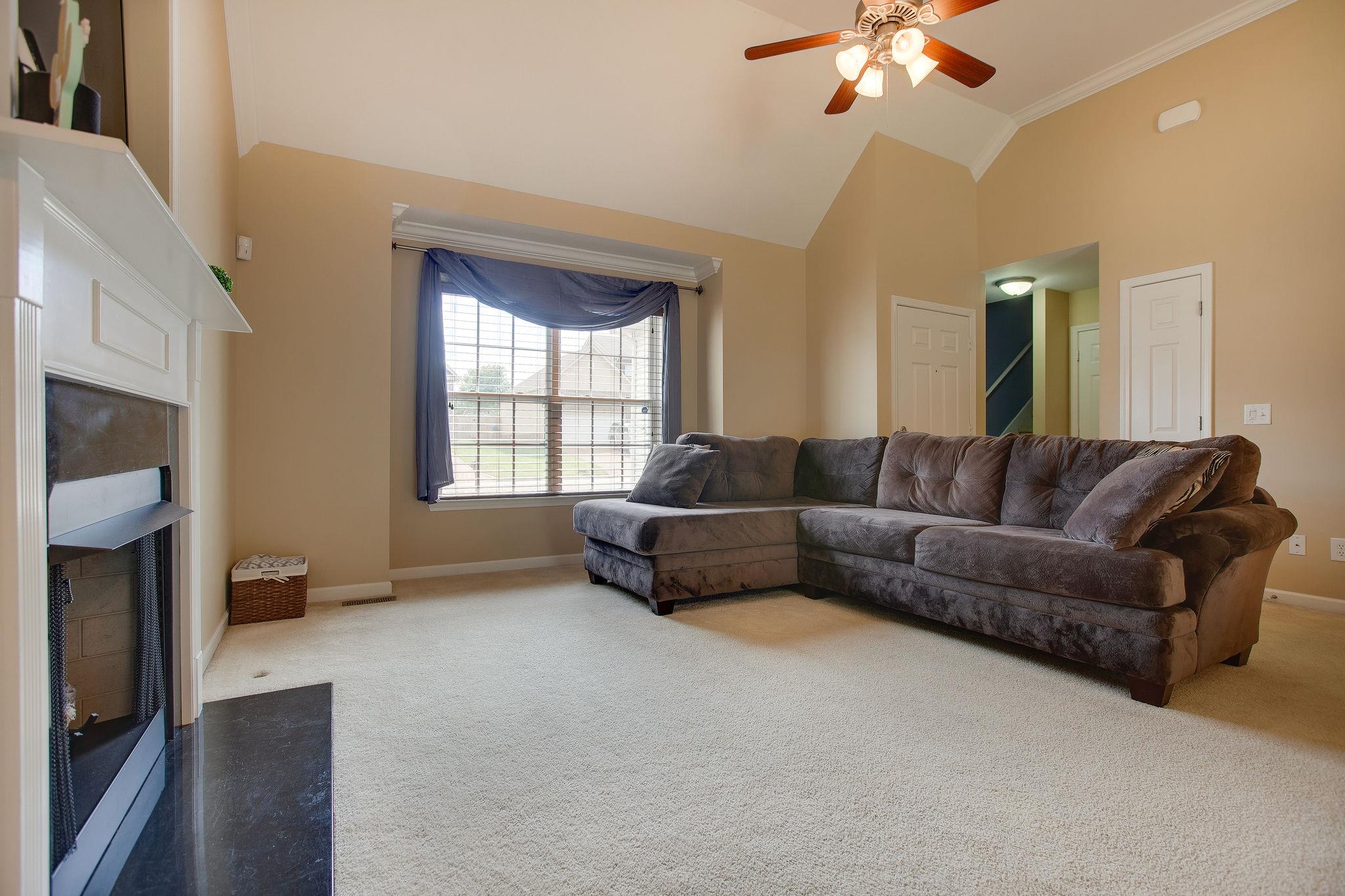 1046 Golf View Way Spring Hill, TN 37174 - Photo 7 of 22 a living room with furniture and a fireplace
