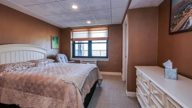 a bedroom with a bed and window