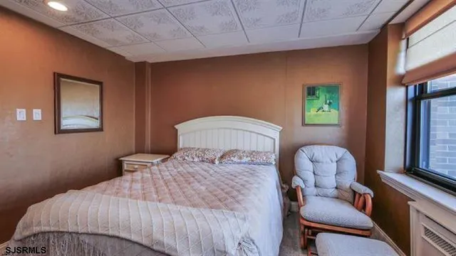 a bedroom with a bed and a chair