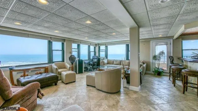 a living room with furniture and a floor to ceiling window