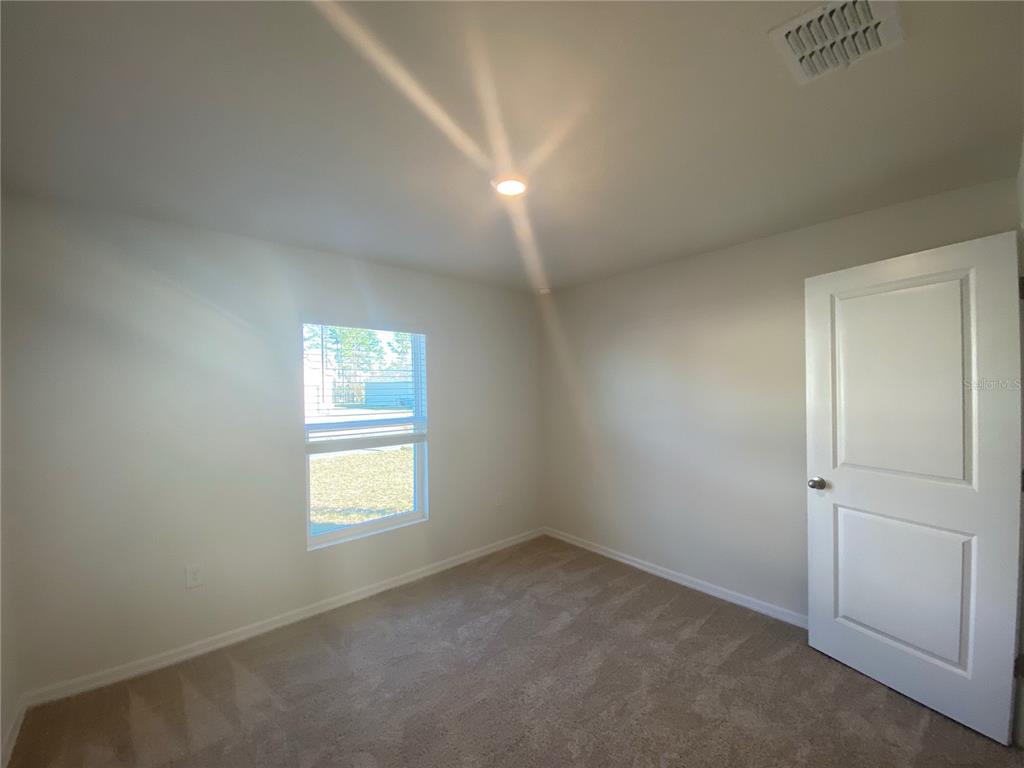 308 Hickory Course Radiel Ocala, FL 34472 - Photo 20 of 24 an empty room with windows and closet