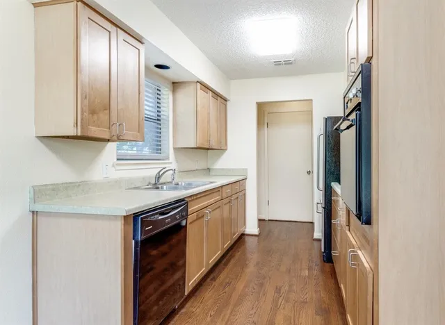a kitchen with a sink stove and refrigerator