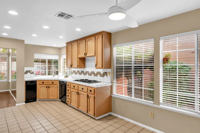 a kitchen with stainless steel appliances granite countertop a stove and cabinets