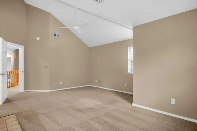 a view of an empty room with windows