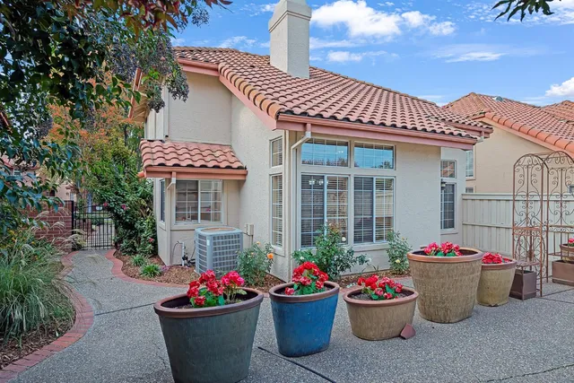 a group of people sitting in front of a house