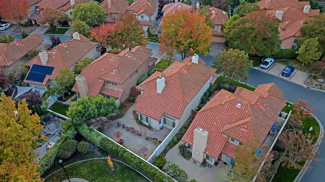 an aerial view of residential houses with outdoor space