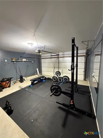 a room with gym equipment and a large window
