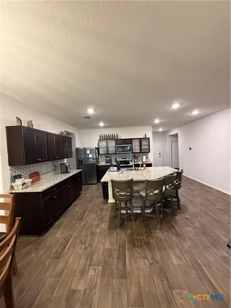 a kitchen with a table and chairs in it