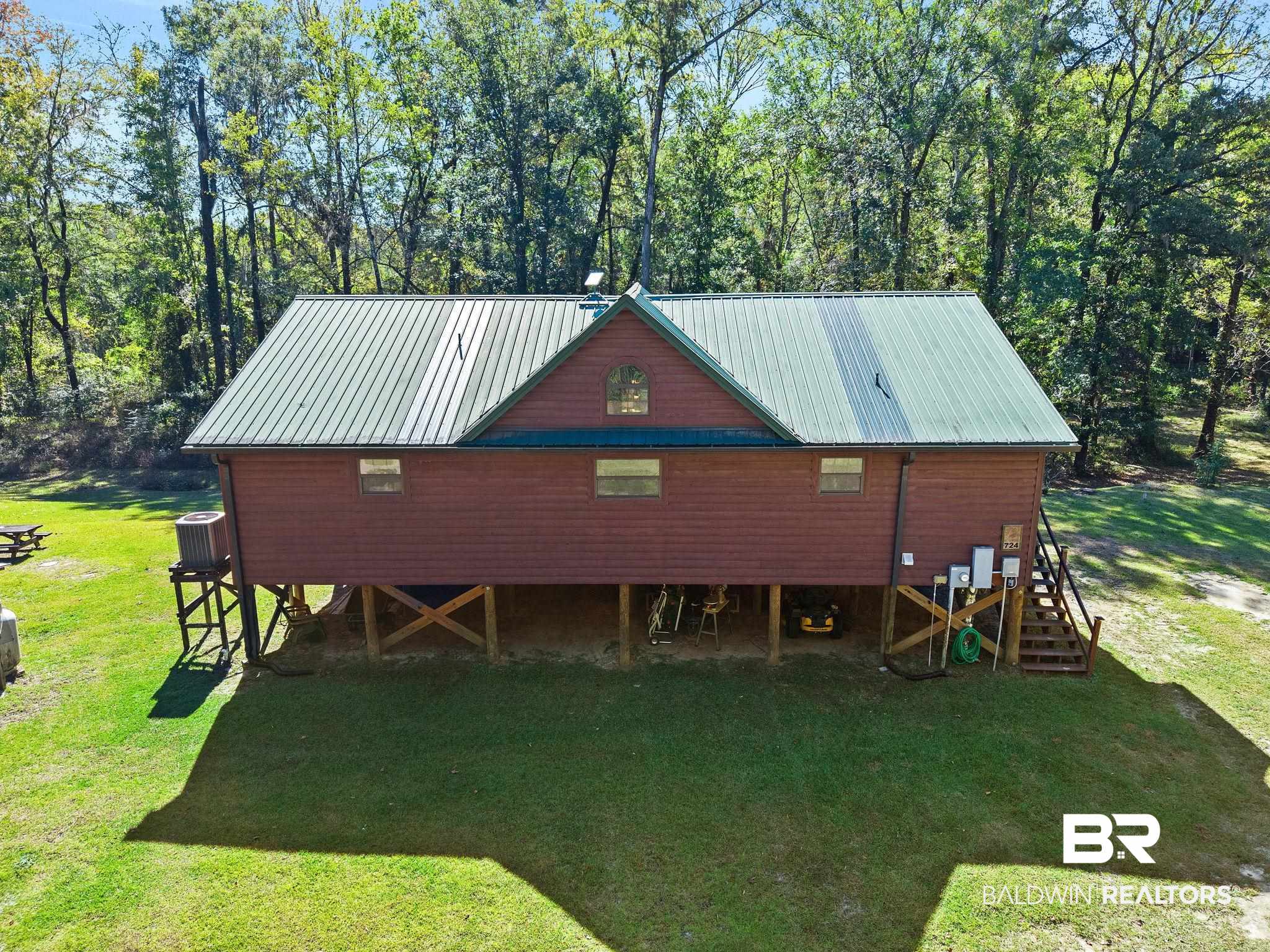 724 Rowell Lane Brewton, AL 36426 - Photo 6 of 40 Chalet / cabin with a front yard, a metal roof, and a deck