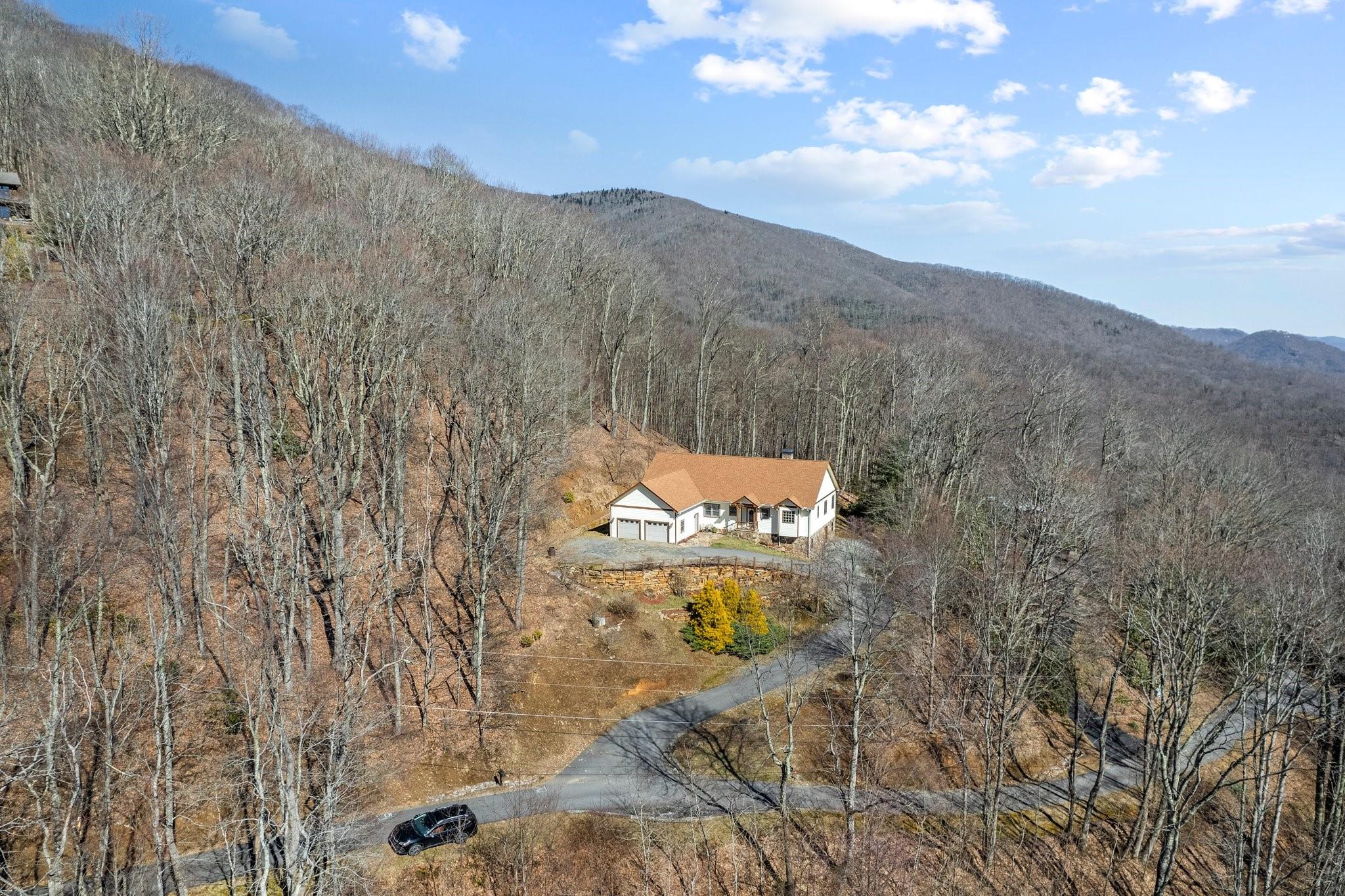400 The High Road Waynesville, NC 28786 - Photo 3 of 36 a view of a dry yard with mountains in the background