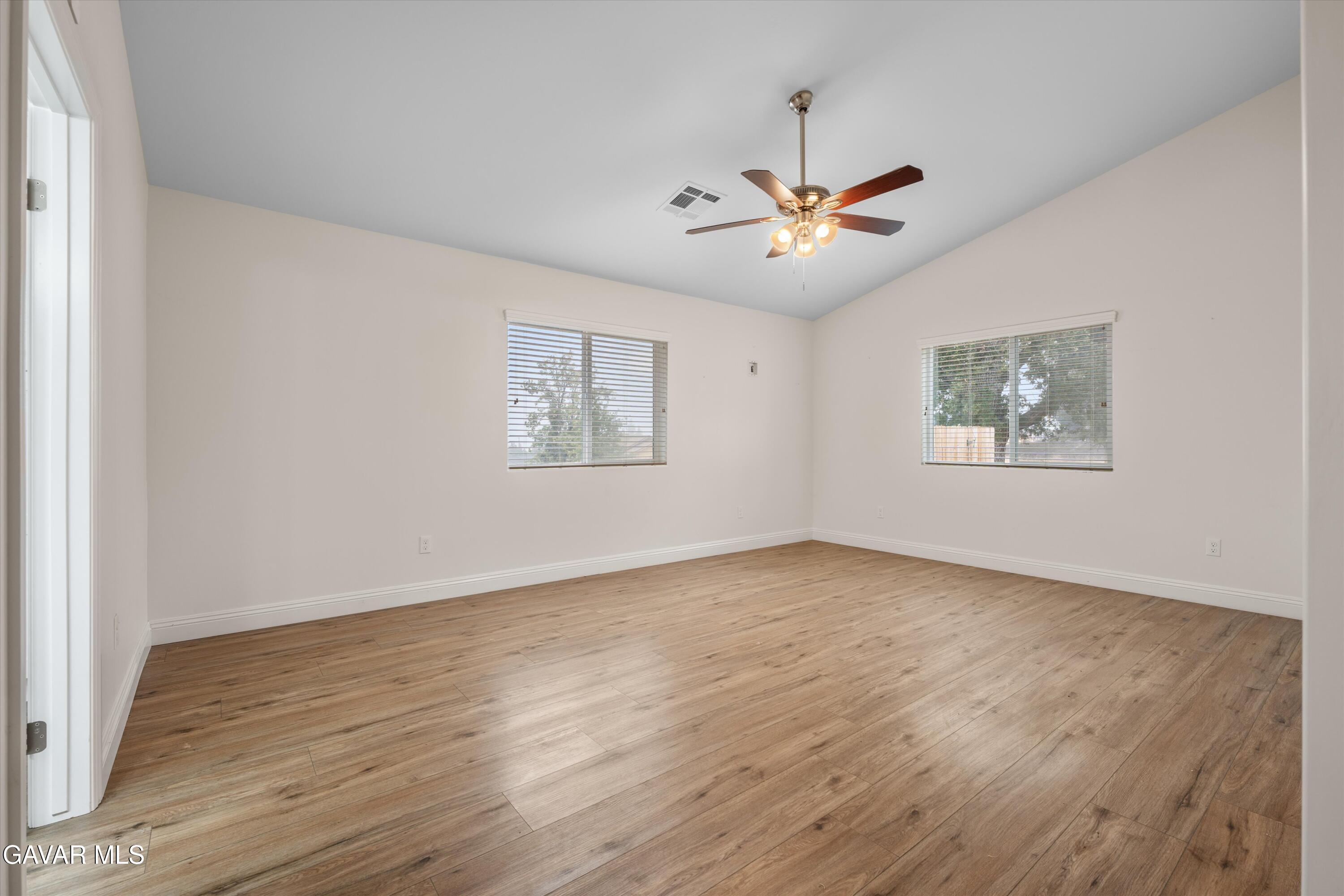 17841 Hambletonian Drive Tehachapi, CA 93561 - Photo 11 of 22 a view of an empty room with a window and wooden floor